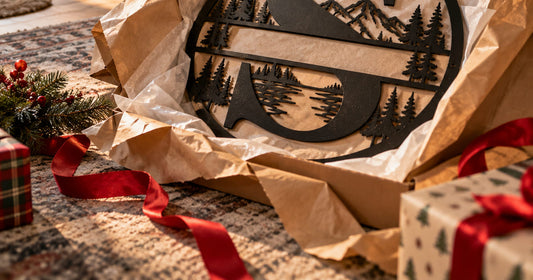 A personalized metal sign partly unwrapped on Christmas morning among kraft paper and red ribbon