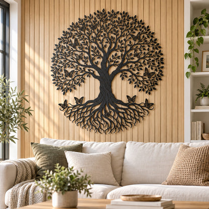 Black steel Tree of Life wall art with butterflies in the branches and on the roots above a cream sofa on a wood slat wall