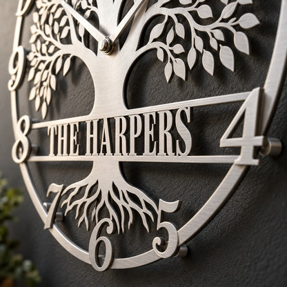 Close up of the family name banner, numerals and laser cut roots on a silver Tree of Life metal wall clock